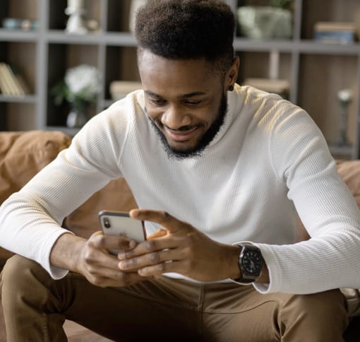 A young black man texting over the cell phone